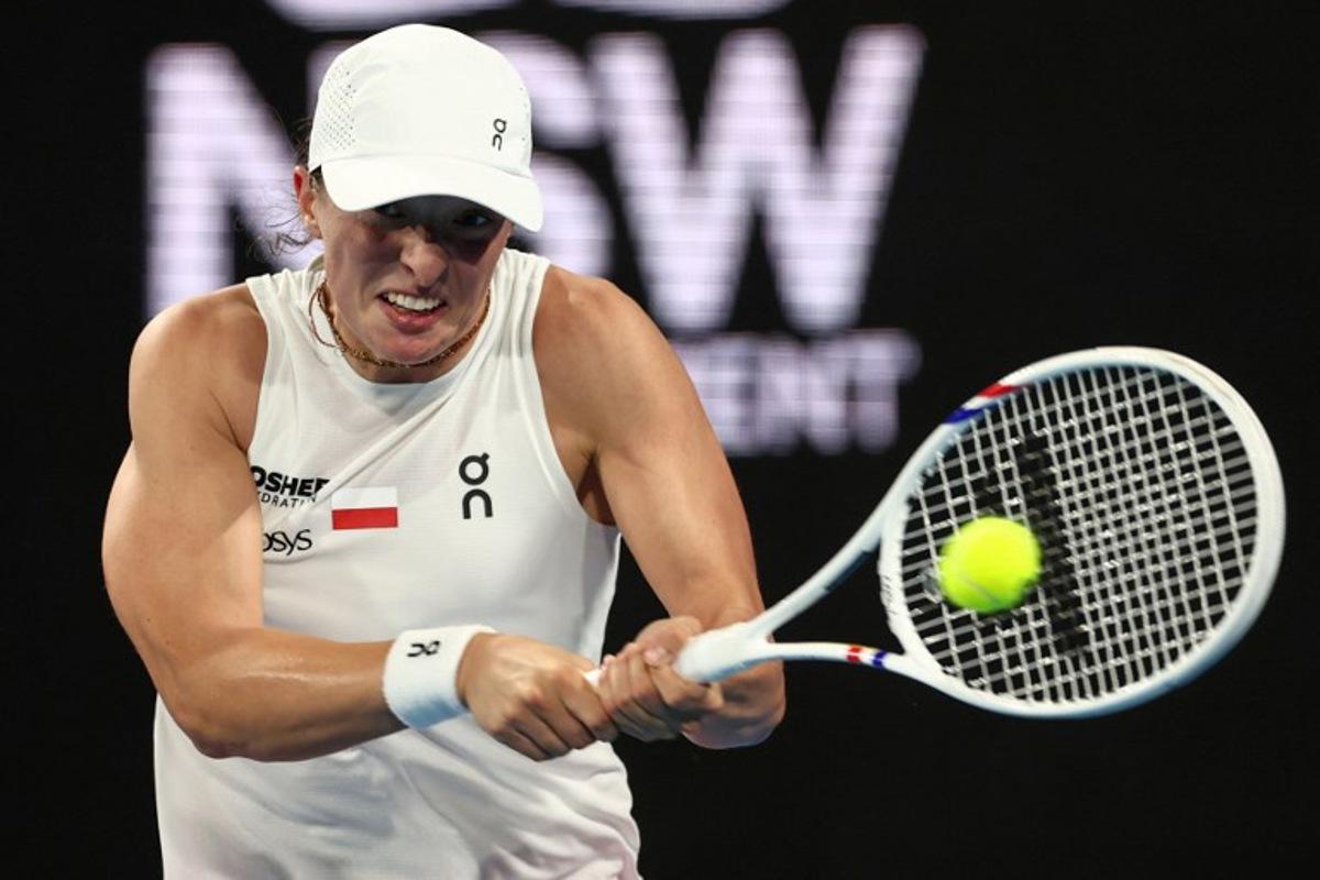Poland's Iga Swiatek hits a return to Germany's Eva Lys during their women's singles match at the United Cup tennis tournament in Ken Rosewall Arena, Sydney on January 5, 2026.  Izhar KHAN / AFP