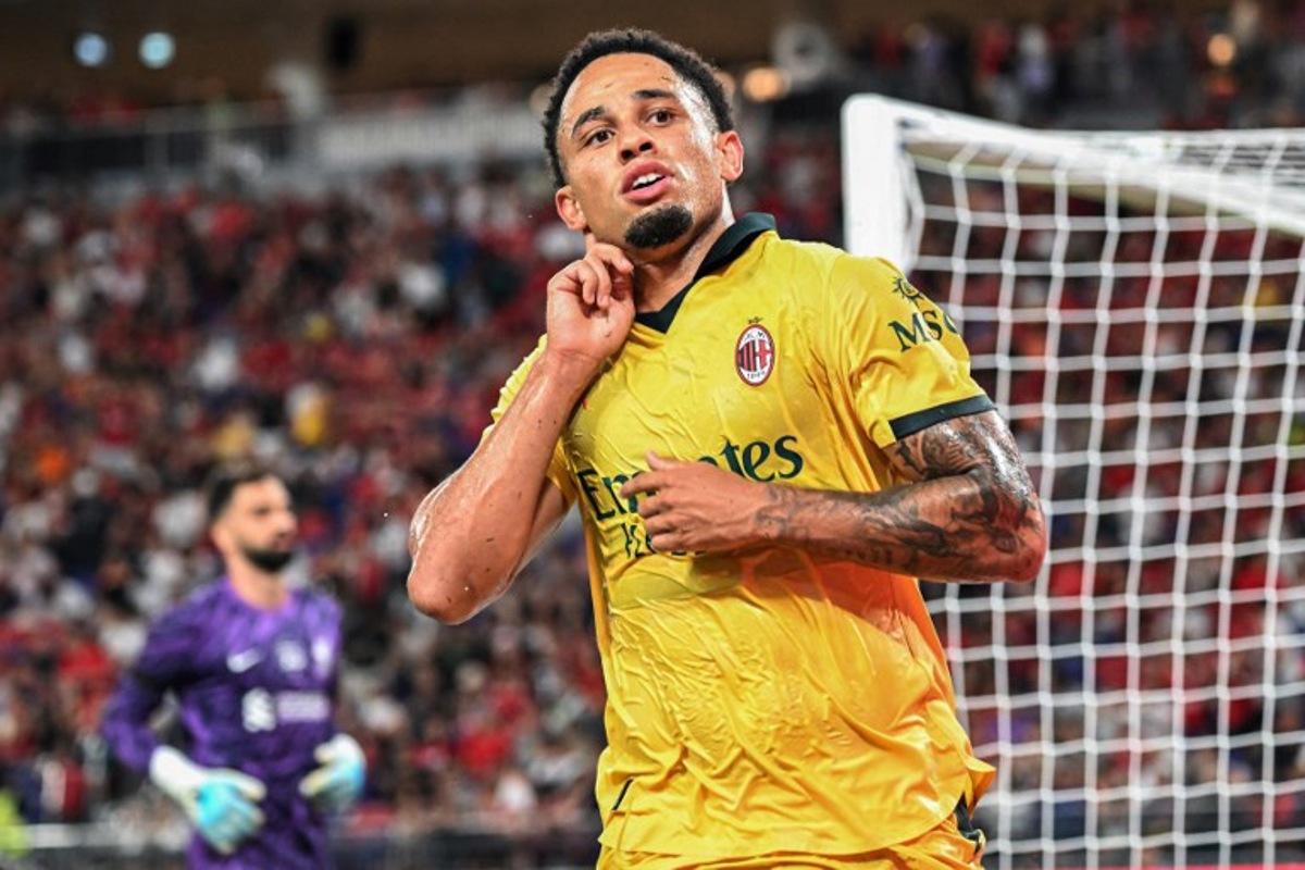 AC Milan's Noah Okafor celebrates after beating Liverpool goalkeeper Alisson Becker (L) to score a goal in their friendly exhibition football match against Liverpool at the Kai Tak Stadium in Hong Kong on July 26, 2025.  Peter PARKS / AFP