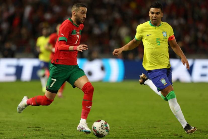 Morocco's midfielder Hakim Ziyech is marked by Brazil's midfielder Casemiro (R) during a friendly football match between Morocco and Brazil at the Ibn Batouta Stadium in Tangier on March 26, 2023.  Fadel Senna / AFP