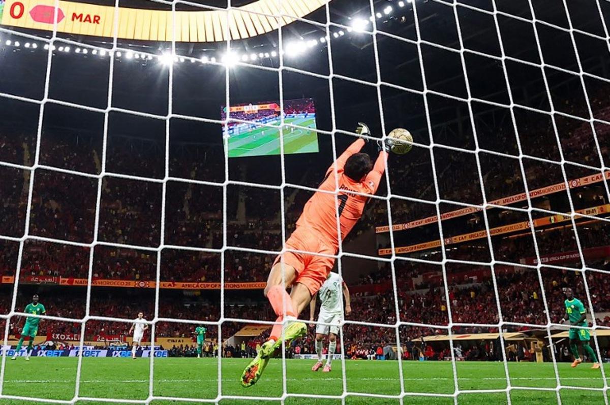 Morocco's goalkeeper #01 Yassine Bounou foils an attempt during the Africa Cup of Nations (CAN) final football match between Senegal and Morocco at the Prince Moulay Abdellah Stadium in Rabat on January 18, 2026.  FRANCK FIFE / AFP