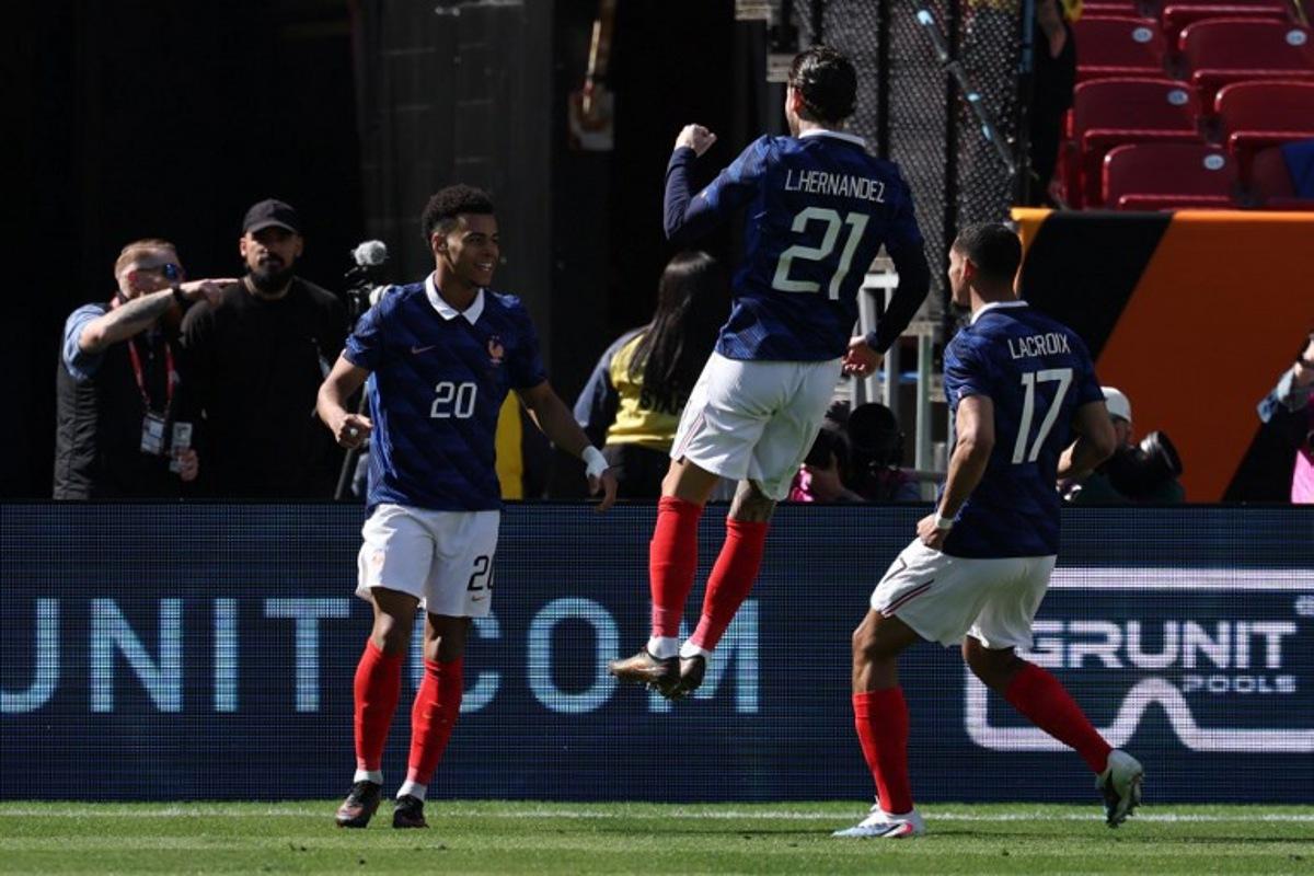 France's forward #20 Desire Doue celebrates with France's defender #21 Lucas Hernandez and France's defender #17 Maxence Lacroix after scoring during a friendly football match between Colombia and France at Northwest Stadium in Landover, Maryland, on March 29, 2026.  FRANCK FIFE / AFP