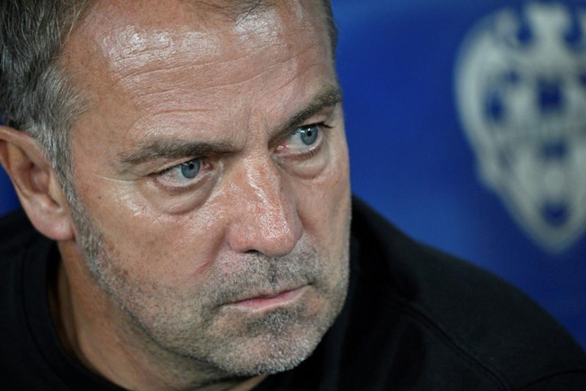 Barcelona's German coach Hans-Dieter Flick looks on prior the Spanish league football match between Levante UD and FC Barcelona at Ciutat de Valencia Stadium in Valencia on August 23, 2025.  Jose JORDAN / AFP
