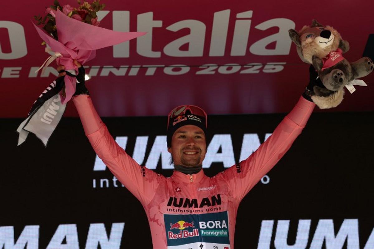 Red Bull-Bora-Hansgrohe's Slovenian rider Primoz Roglic celebrates the Pink jersey of the overall leader on the podium after the 7th stage of the 108th Giro d'Italia cycling race 168kms from Castel di Sangro to Tagliacozzo on May 16, 2025.  Luca Bettini / AFP