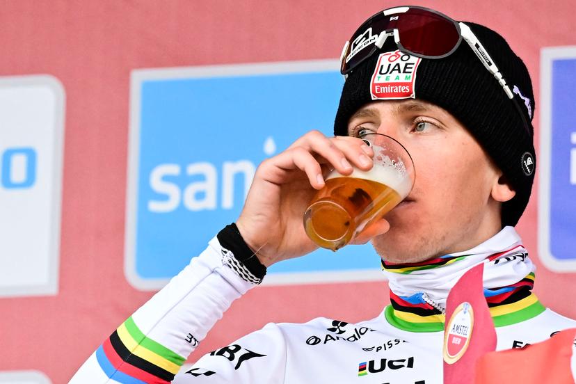 Slovenian Tadej Pogacar of UAE Team Emirates pictured on the podium drinking an Amstel beer after the men elite 'Amstel Gold Race' one day cycling race, 255,9 km from Maastricht to Valkenburg, The Netherlands, Sunday 20 April 2025. BELGA PHOTO DIRK WAEM