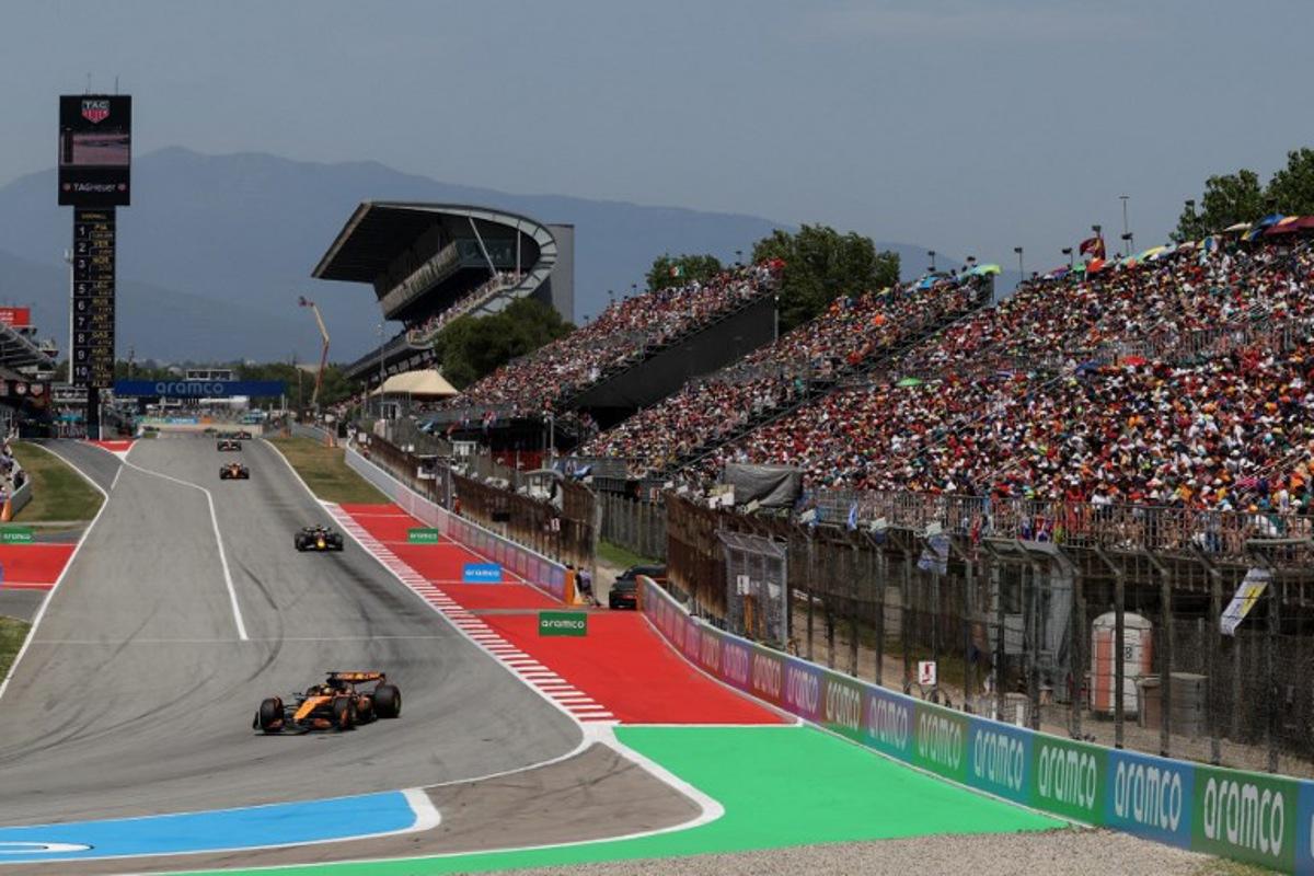 McLaren's Australian driver Oscar Piastri (C) leads Red Bull Racing's Dutch driver Max Verstappen in front of a fully packed spectators grandstand during the Spanish Formula One Grand Prix at the Circuit de Catalunya in Montmelo, on the outskirts of Barcelona, on June 1, 2025.  LLUIS GENE / AFP