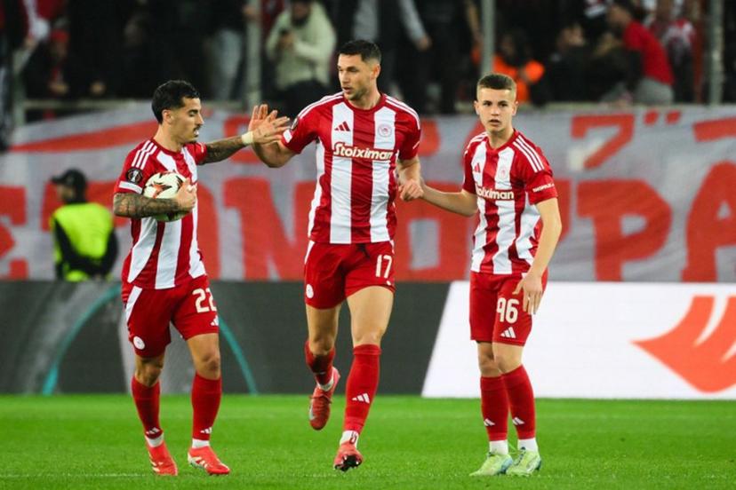 Olympiakos' Ukrainian forward #17 Roman Yaremchuk (C) celebrates with teammates Olympiakos' Portuguese mifielder #22 Chiquinho (L) and Olympiakos' Greek midfielder #96 Christos Mouzakitis (R) after scoring the 2-1 goal during the second leg last 16 UEFA Europa League football match between Olympiacos (GRE) and Bodo/Glimt (NOR) at Stadio Georgios Karaiskakis in Piraeus on March 13, 2025.   Angelos TZORTZINIS / AFP