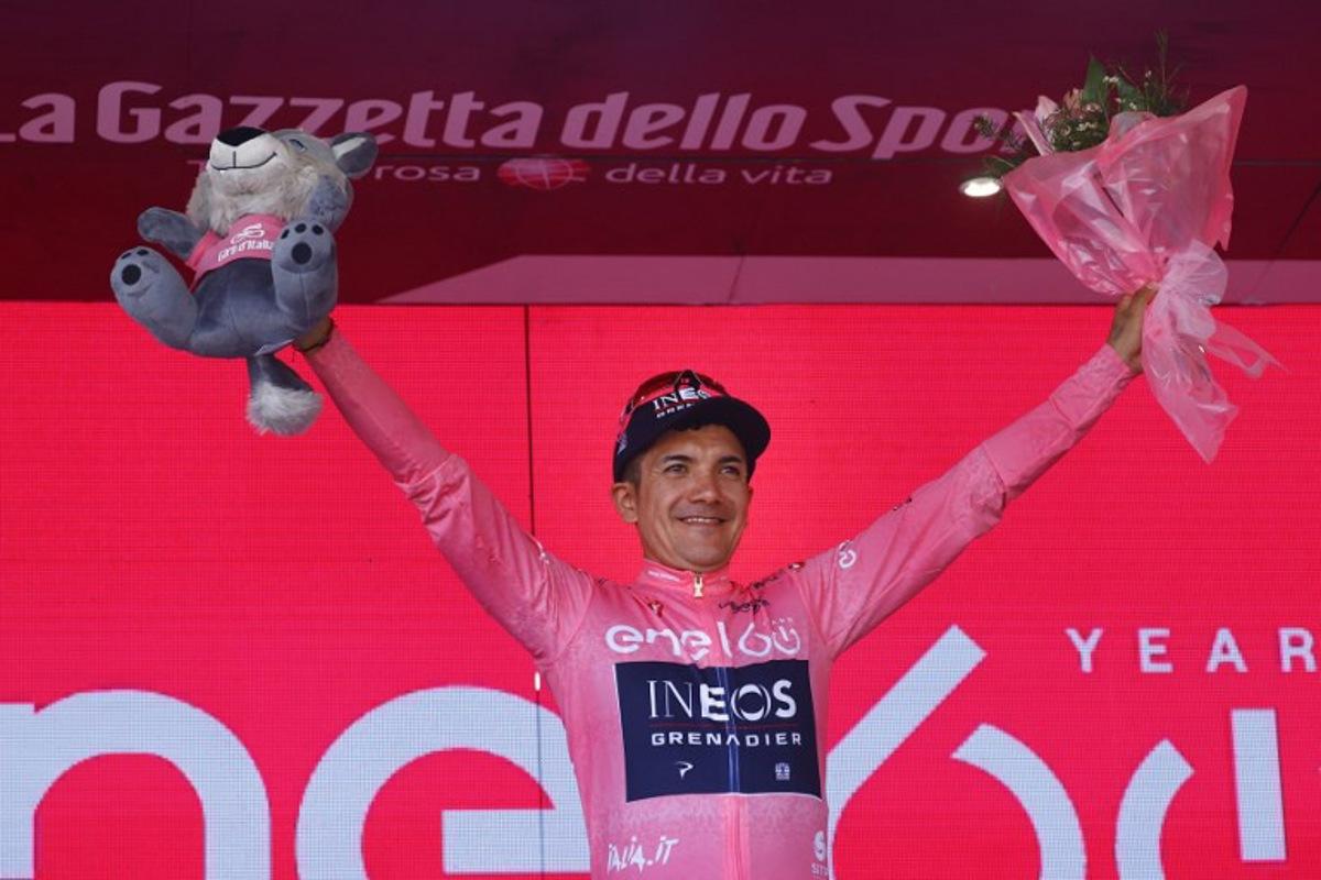 Overall leader Team Ineos' Ecuadorian rider Richard Carapaz celebrates on the podium after the 19th stage of the Giro d'Italia 2022 cycling race, 178 kilometers from Marano Lagunare to Santuario di Castelmonte, northeastern Italy, on May 27, 2022.  Luca Bettini / AFP