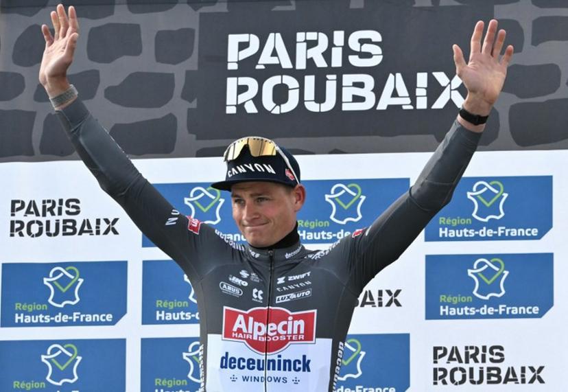 First placed Alpecin-Deceuninck's Dutch rider Mathieu van der Poel celebrates on the podium of the 122nd edition of the Paris-Roubaix one-day classic cycling race, 259,2 km between Compiegne and Roubaix, northern France on April 13, 2025.  Jeff PACHOUD / AFP