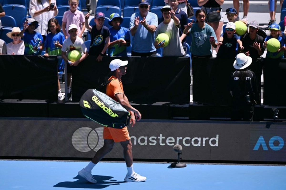Canada's Felix Auger-Aliassime walks off the court after retiring from an injury in his men's singles match against Portugal's Nuno Borges on day two of the Australian Open tennis tournament in Melbourne on January 19, 2026.  WILLIAM WEST / AFP