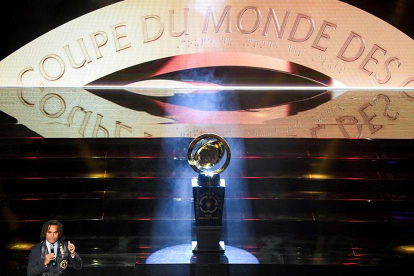 France's former football midfielder and FIFA World Cup winner Christian Karembeu presents the FIFA Club World Cup trophy during a ceremony organised by Tunisian club Esperance de Tunis in Tunis on February 15, 2025. Tunisia's Esperance is one of the clubs taking part in the 2025 FIFA Club World Cup championship in June in the United States. FETHI BELAID / AFP