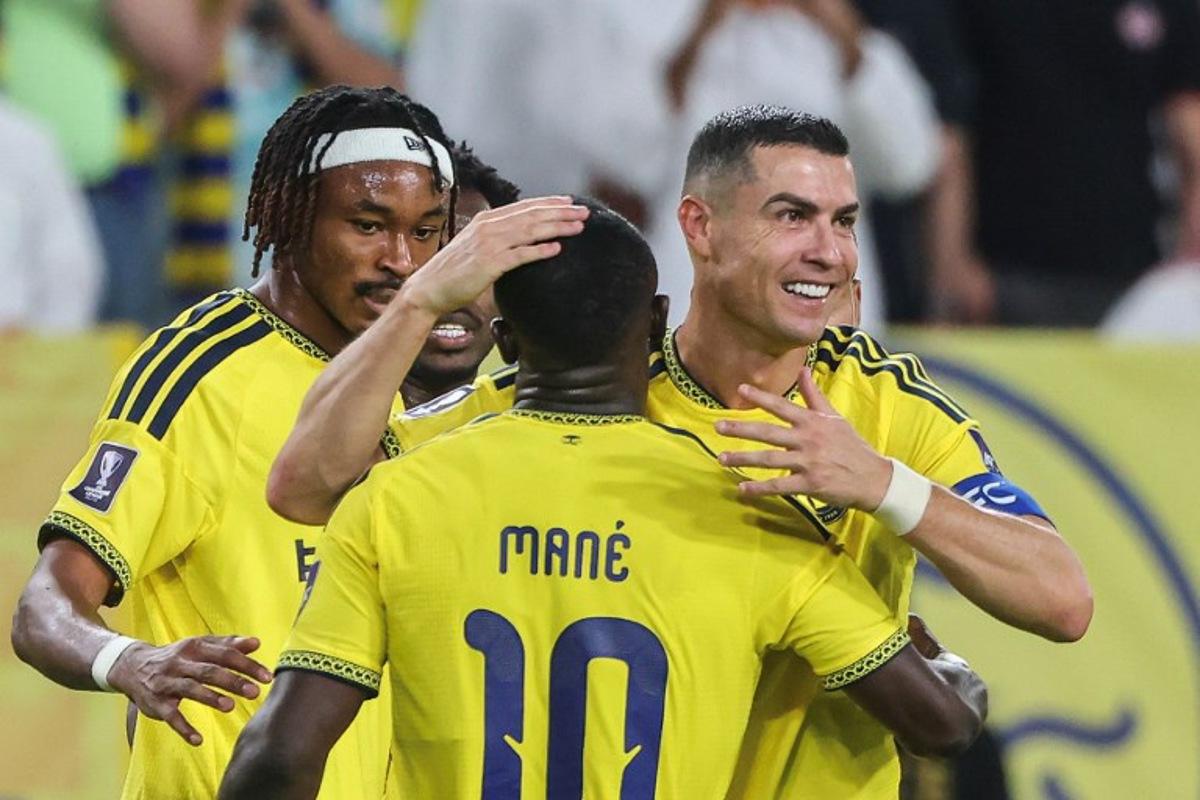Nassr's Portuguese forward #07 Cristiano Ronaldo celebrates with Nassr's Senegalese Forward #10 Sadio Mane after scoring his team's second goal during the AFC Champions League group B football match between Al-Nassr and Neftchi Fergana at the Alawwal Park stadium in Riyadh on October 12, 2026.  Fayez NURELDINE / AFP