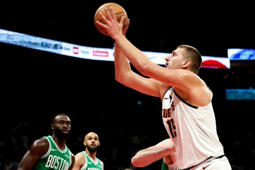 Denver Nuggets' center #15 Nikola Jokic jumps to shoot during the NBA Preseason game between the Boston Celtics and the Denver Nuggets at the Etihad Arena in Abu Dhabi on October 6, 2024.  Fadel Senna / AFP