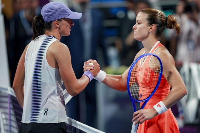 Greece's Maria Sakkari (R) is congratulated by Poland's Iga Swiatek after winning their women's singles quarter-final match at the Qatar Open tennis tournament in Doha on February 12, 2026.  Karim JAAFAR / AFP