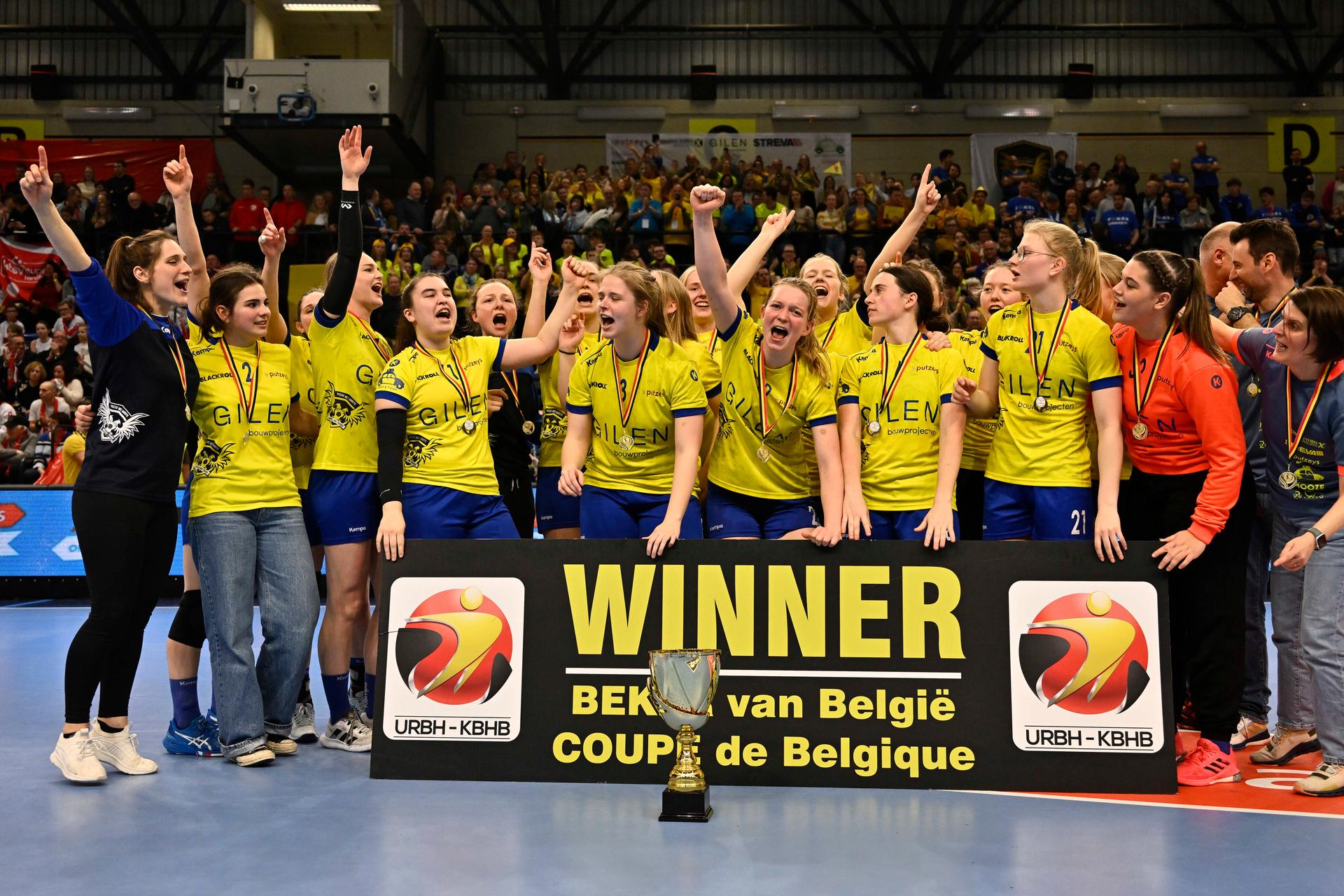 Sint Truiden's players, celebrate and after winning the cup during a game between KTSV Eupen and HB Sint-Truiden, the women's final of the Belgian handball cup, Saturday 01 April 2023, in Hasselt. BELGA PHOTO JOHAN EYCKENS