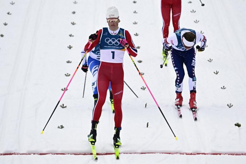 Norway's Johannes Hoesflot Klaebo crosses the finish to win in heat 1 of the men's cross country sprint classic semifinal event of the Milano Cortina 2026 Winter Olympic Games at Tesero Cross-Country Skiing Stadium in Lago di Tesero (Val di Fiemme), on February 10, 2026.  Tobias SCHWARZ / AFP