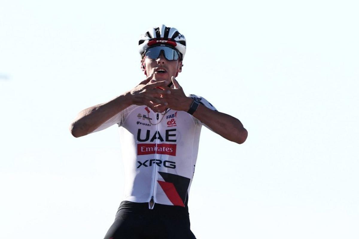UAE Team Emirates XRG Switzerland's Jan Christen celebrates his victory as he crosses the finish line of the fifth and last stage of the AlUla Tour cycling race, 163.9km from Alula Old Town to Skyviews of Harrat Uwayrid on January 31, 2026.  Anne-Christine POUJOULAT / AFP