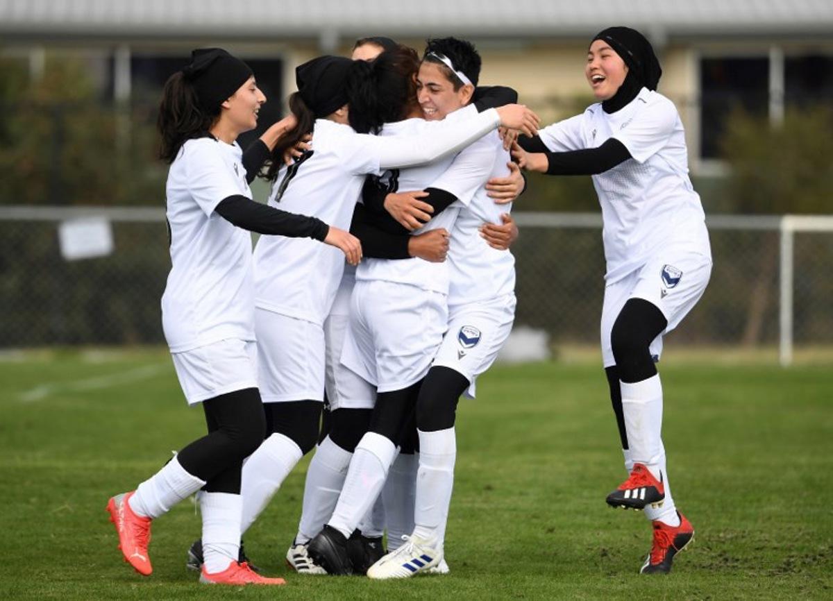 Melbourne Victory Afghan women's team player Manozh (2nd R) and teammates celebrate a goal which was disallowed during their first match in a local league against ETA Buffalo SC in Melbourne on April 24, 2022.  Players from Afghanistan's national women's football team competed in a local league match in Australia on April 24 for the first time since fleeing the hardline Islamist Taliban. William WEST / AFP