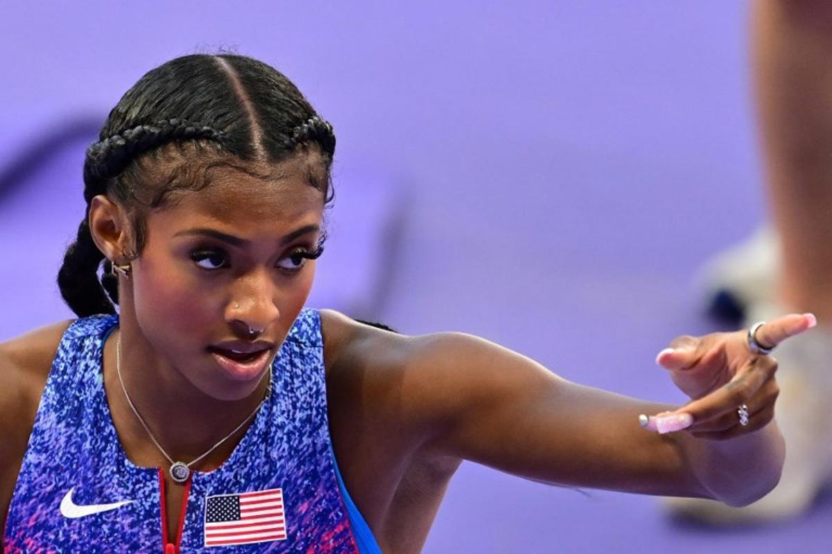 US' Masai Russell reacts after winning the women's 100m hurdles final of the athletics event at the Paris 2024 Olympic Games at Stade de France in Saint-Denis, north of Paris, on August 10, 2024.  Martin  BERNETTI / AFP