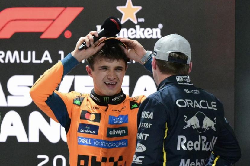 (L/R) Pole position winner McLaren's British driver Lando Norris speaks to 2nd place finisher Red Bull Racing's Dutch driver Max Verstappen after the qualifying session for the Las Vegas Formula One Grand Prix at the Las Vegas Strip Circuit in Las Vegas, Nevada, on November 21, 2 025.  Frederic J. Brown / AFP