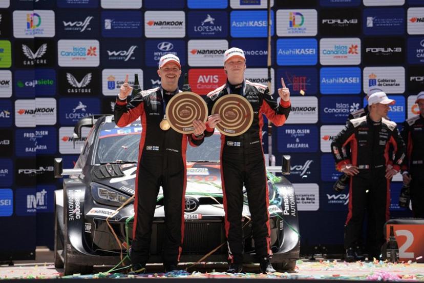 Kalle Rovanpera of Finland (R) and his co-driver Jonne Halttunen of Finland from the team Toyota Gazoo Racing WRT hold their trophies as they celebrate after winning the World Rally Championship (WRC) Rally Islas Canarias on the island of Gran Canaria in Spain's Canary Islands, on April 27, 2025.  Manaure QUINTERO / AFP