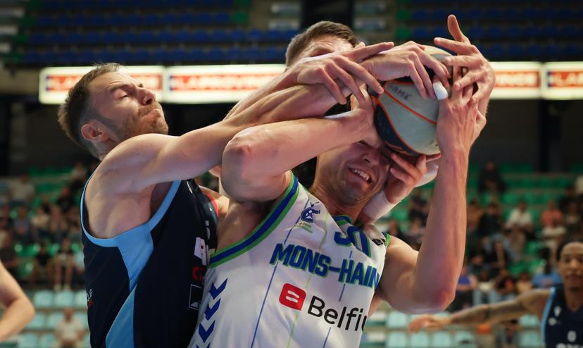 Brussels' Alexandre Libert, Mons' Brock Cunningham and Brussels' Yannick Desiron fight for the ball during a basketball match between Brussels Basketball and Mons-Hainaut, Wednesday 30 April 2025 in Brussels, on day 34 of the 'BNXT League' Belgian/ Dutch first division basket championship. BELGA PHOTO JOHN THYS