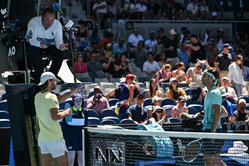 The umpire speaks with Czech Republic's Tomas Machac (L) and Italy's Lorenzo Musetti during their men's singles match on day seven of the Australian Open tennis tournament in Melbourne on January 24, 2026.  Paul Crock / AFP