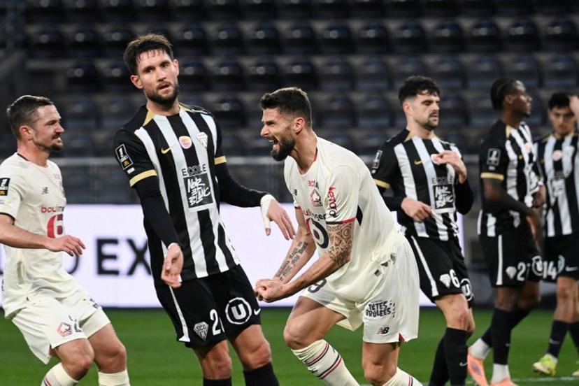 Lille's French forward #09 Olivier Giroud (C) celebrates scoring his team's first goal from the penalty spot during the French L1 football match between SCO Angers and Lille LOSC at the Raymond-Kopa Stadium in Angers, western France, on February 22, 2026.  JEAN-FRANCOIS MONIER / AFP