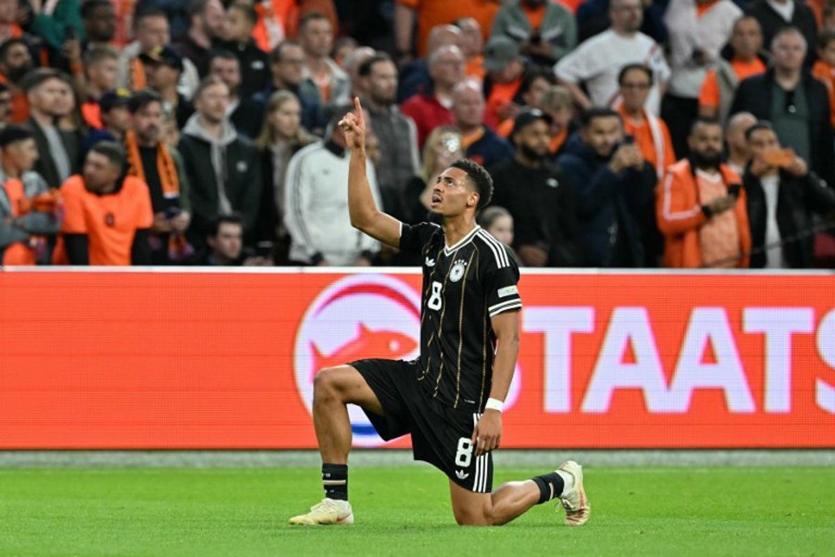 Germany's midfielder #08 Felix Nmecha celebrates after scoring his team's first goal during the UEFA Nations League (League A, Group A2) football match between Netherlands and Germany at Johan Cruijff ArenA in Amsterdam on September 24, 2026.  NICOLAS TUCAT / AFP