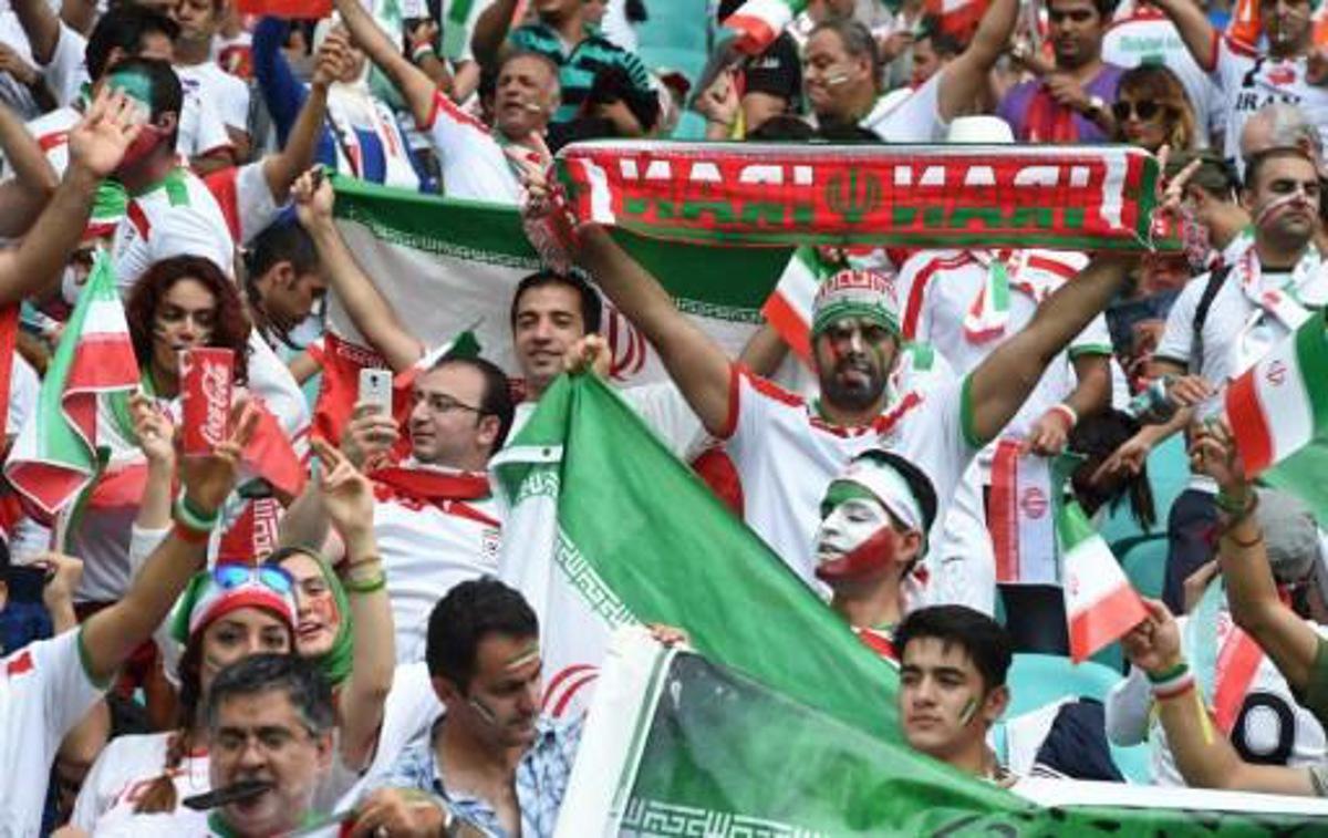 Fans of Iran react during a Group F football match between Bosnia-Hercegovina and Iran at the Fonte Nova Arena in Salvador during the 2014 FIFA World Cup on June 25, 2014. AFP PHOTO / JAVIER SORIANO FOR EDITORIAL REPORTS, NO ALERT/PUSH TO MOBILE