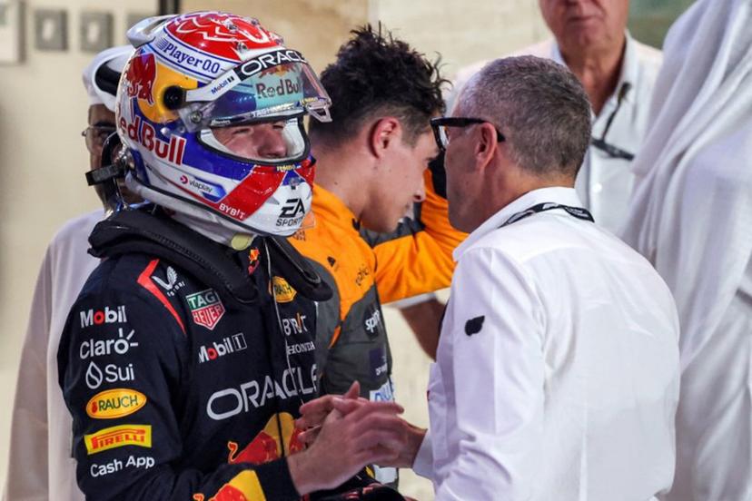 Red Bull Racing's Dutch driver Max Verstappen (L) is congratulated by Formula One CEO Stefano Domenicali (R) after the sprint race ahead of the Qatari Formula One Grand Prix at the Lusail International Circuit on October 7, 2023.  Giuseppe CACACE / AFP