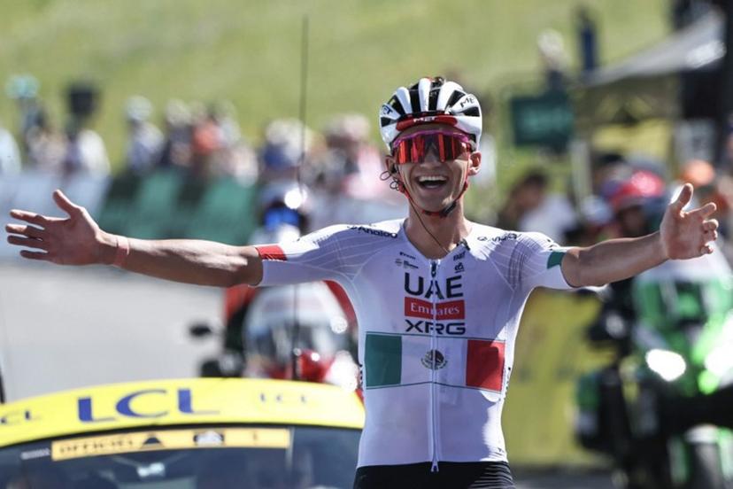 UAE Team Emirates XRG's Mexican rider Isaac Del Toro Romero celebrates as he cycles to the finish line to win the 8th and final stage of the Tour Auvergne-Rhone-Alpes cycling race (formerly known as the Criterium du Dauphine), 120,1km between Beaufort and Plateau de Solaison, in the French Alps on June 14, 2026.  Anne-Christine POUJOULAT / AFP