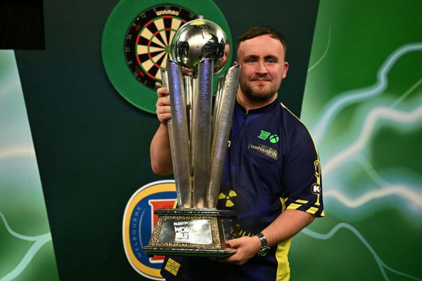 England's Luke Littler poses with the Sid Waddell Trophy after victory over Netherlands' Michael van Gerwen in the PDC World Darts Championship final, at Alexandra Palace in London on January 3, 2025. Luke Littler became darts' youngest world champion at just 17 after thrashing three-time winner Michael van Gerwen in front of an adoring home crowd at London's Alexandra Palace on Friday. This time there was no stopping "Luke the Nuke" as he stormed past Dutchman Van Gerwen by seven sets to three. Ben STANSALL / AFP