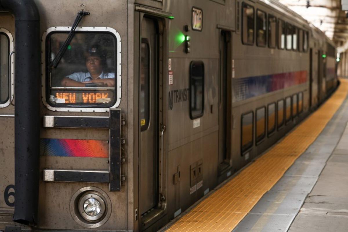 An NJ Transit train bound for New York pulls into Newark Penn Station in Newark, New Jersey on April 17, 2026. Football fans have expressed outrage at the exorbitant price of transit fares to get to World Cup matches, following reports that US transport authorities have jacked up prices just for this summer's tournament. New Jersey Transit is planning to charge fans more than $100 for tickets from Penn Station in Manhattan to MetLife Stadium in New Jersey during the World Cup, according to a report in The Athletic. A return ticket for the journey normally costs $12.90.  CHARLY TRIBALLEAU / AFP