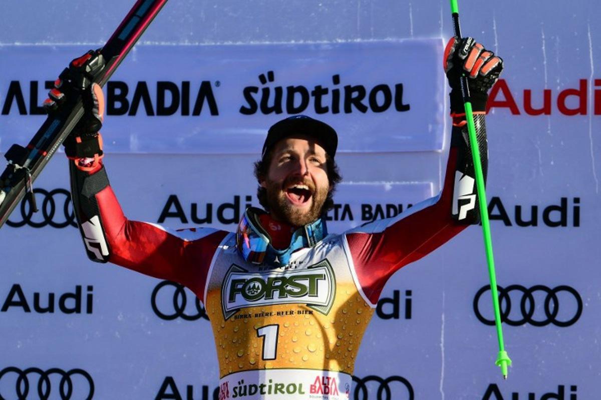 Race winner Austria's Marco Schwarz celebrates on the podium after competing in the men's giant slalom part of the FIS Alpine Ski World Cup 2025-2026, in Alta Badia, northern Italy, on December 21, 2025.  Stefano RELLANDINI / AFP