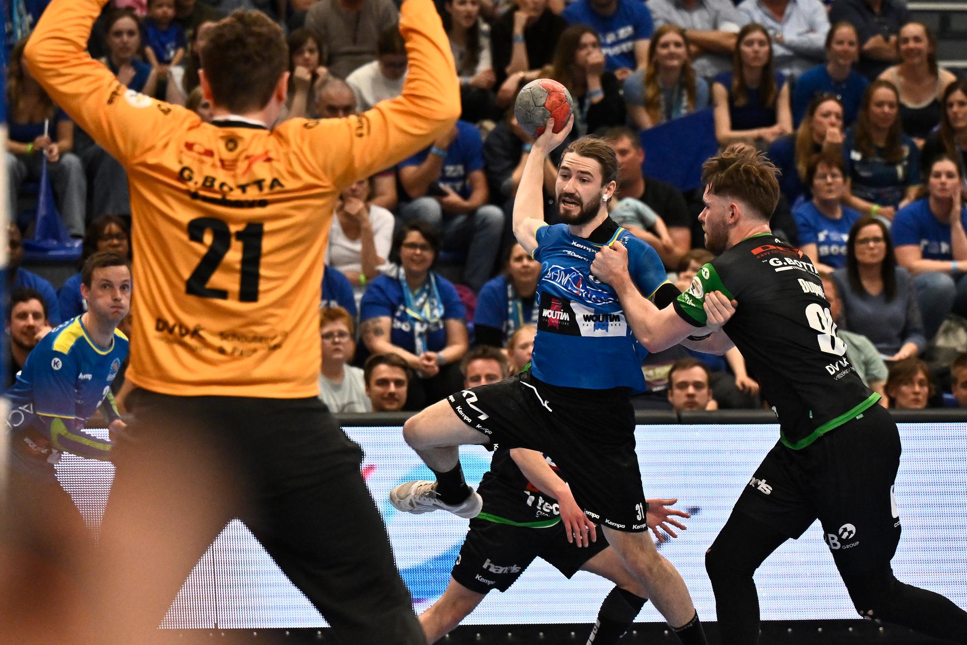 Bocholt's Pieter Strauven and Hubo Hasselt's Vio Bosca fight for the ball during a handball game between Hubo handbal Hasselt and Achilles Bocholt, Saturday 19 April 2025, in Hasselt, the men's final of the Belgian handball cup. BELGA PHOTO JOHAN EYCKENS