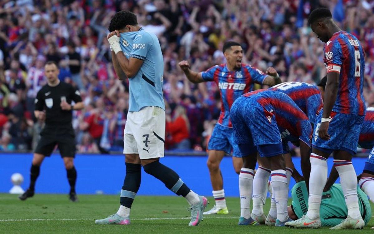 Manchester City's Egyptian striker #07 Omar Marmoush reacts as Crystal Palace's English goalkeeper #01 Dean Henderson is mobbed by teammates after saving a penalty during the English FA Cup final football match between Crystal Palace and Manchester City at Wembley stadium in London, on May 17, 2025.  Adrian Dennis / AFP