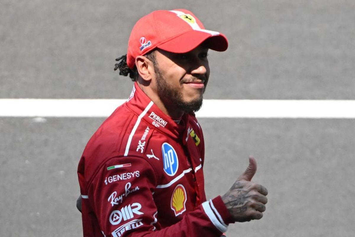 Ferrari's British driver Lewis Hamilton celebrates after winning the sprint race of the Formula One Chinese Grand Prix at the Shanghai International Circuit in Shanghai on March 22, 2025.  JADE GAO / AFP