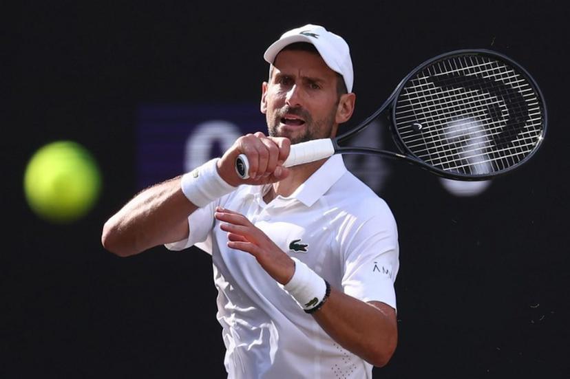 Serbia's Novak Djokovic returns to Italy's Jannik Sinner during their men's singles semi-final tennis match on the twelfth day of the 2026 Wimbledon Championships at The All England Lawn Tennis and Croquet Club in Wimbledon, southwest London, on July 10, 2026.  HENRY NICHOLLS / AFP