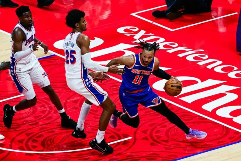 New York Knicks' #11 Jalen Brunson dribbles against Philadelphia 76ers' #25 Dominick Barlow during the NBA basketball game between the New York Knicks and the Philadelphia 76ers at the Etihad Arena in Abu Dhabi on October 4, 2025.  Giuseppe CACACE / AFP