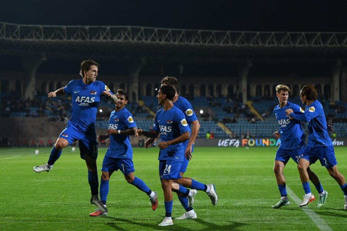 AZ Alkmaar's Danish midfielder Valdemar Byskov (L) celebrates after scoring the team's first goal during the UEFA Europa League football match between Ararat-Armenia and AZ Alkmaar at the Republican Stadium named after Vazgen Sargsyan in Yerevan on October 22, 2026.  KAREN MINASYAN / AFP