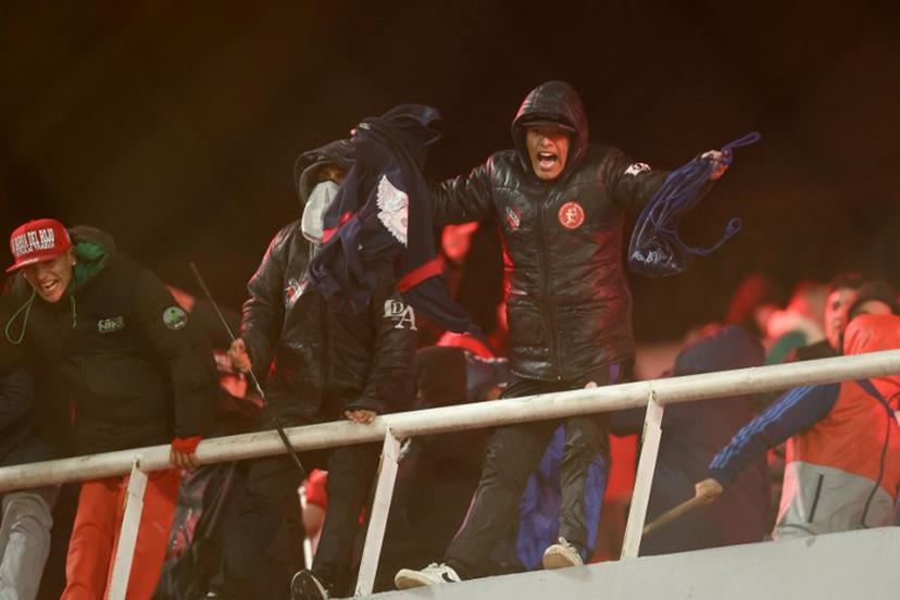 A fan of Independiente shouts during the interruption of the Copa Sudamericana round of 16 second leg football match between Argentina's Independiente and Chile's Universidad de Chile at the Libertadores de America stadium in Avellaneda, Buenos Aires province, Argentina on August 20, 2025. The match between Independiente and Universidad de Chile was suspended due to incidents in the stands during the second half, according to the Argentine club and confirmed by Conmebol. The score was tied 1-1. Alejandro PAGNI / AFP
