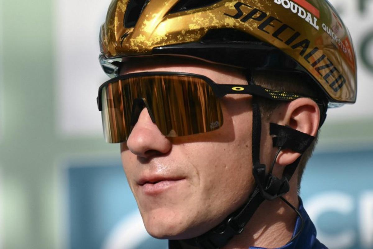 Soudal Quick-Step team's Belgian rider Remco Evenepoel looks on from the presentation podium before the start of 118th edition of the Giro di Lombardia (Tour of Lombardy), a 252km cycling race from Bergamo to Como on October 12, 2024.  Marco BERTORELLO / AFP