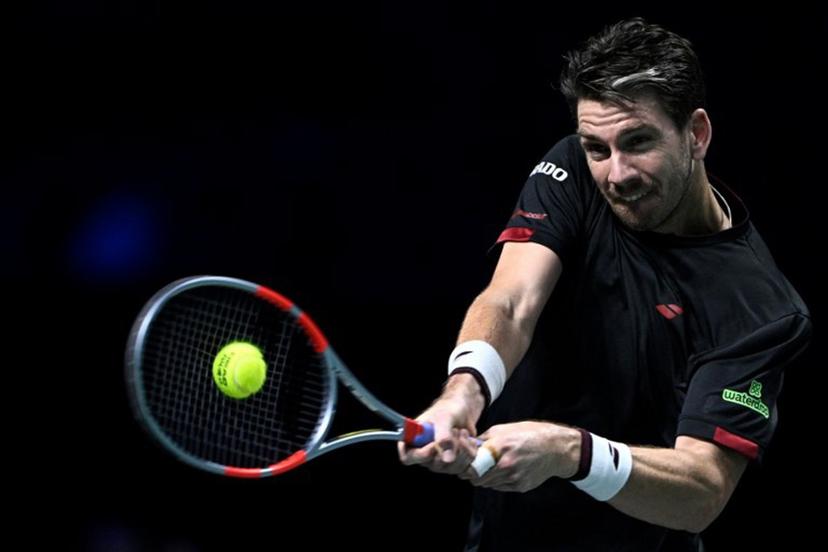 Britain's Cameron Norrie plays a backhand return to Monaco's Valentin Vacherot during their men's singles match on day four of the Paris ATP Masters 1000 tennis tournament at the Paris La Défense Arena in Nanterre, on the outskirts of Paris, on October 30, 2025.  JULIEN DE ROSA / AFP