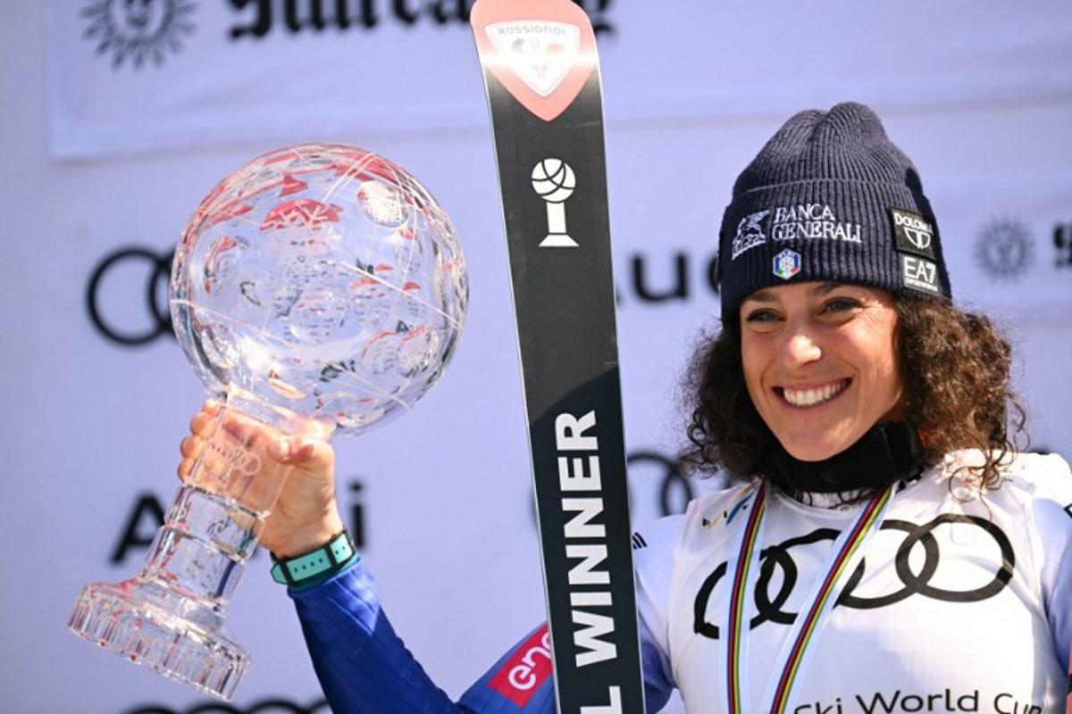 Women's overall winner Federica Brignone celebrates with the crystal globe on the podium at the 2025 FIS Alpine World Cup Finals at Sun Valley Resort in Sun Valley, Idaho, on March 27, 2025.  Patrick T. Fallon / AFP