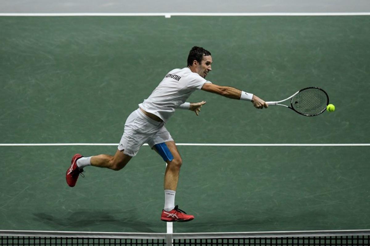 Kazakhstan's Mikhail Kukushkin returns the ball to Serbia's Miomir Kecmanovic during the men's singles quarter-final tennis match between Serbia and Kazakhstan of the Davis Cup tennis tournament at the Madrid arena in Madrid on December 1, 2021.  OSCAR DEL POZO / AFP