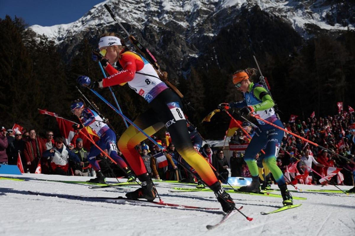 France's Oceane Michelon (L), Belgium's Maya Cloetens (C) and Slovenia's Anamarija Lampic (R) compete during the Women 10 km Pursuit event of the IBU Biathlon World Championship of Lenzerheide, eastern Switzerland, on February 16, 2025.  FRANCK FIFE / AFP