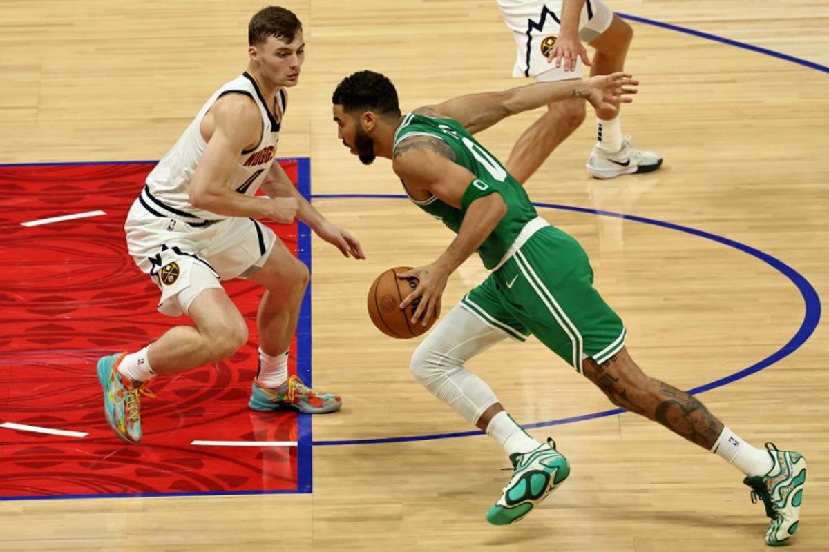 Denver Nuggets' forward #0 Christian Braun fights for the ball with Boston Celtics' forward #0 Jayson Tatum during the NBA Preseason game between the Denver Nuggets and the Boston Celtics at the Etihad Arena in Abu Dhabi on October 4, 2024.  Fadel Senna / AFP