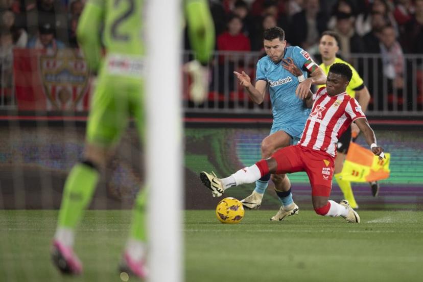 Athletic Bilbao's Spanish defender #18 Oscar De Marcos (L) fights for the ball with Almeria's Belgian forward #07 Largie Ramazani during the Spanish league football match between UD Almeria and Athletic Club Bilbao at the Municipal Stadium of the Mediterranean Games in Almeria on February 12, 2024.  JORGE GUERRERO / AFP