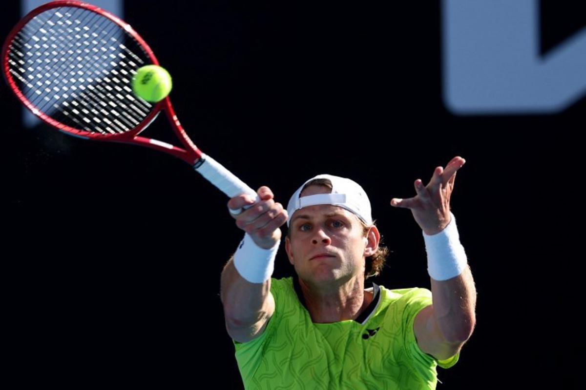 Belgium's Zizou Bergs hits a return to Poland's Hubert Hurkacz during their men's singles match on day three of the Australian Open tennis tournament in Melbourne on January 20, 2026.  IZHAR KHAN / AFP
