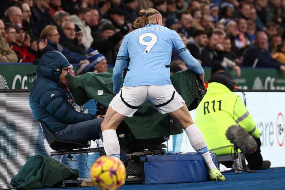 Manchester City's Norwegian striker #09 Erling Haaland runs into a television camera during the English Premier League football match between Leicester City and Manchester City at King Power Stadium in Leicester, central England on December 29, 2024.  Darren Staples / AFP